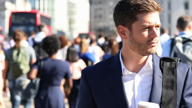 Businessman With Takeaway Drink Walking To Work In Slow Motion