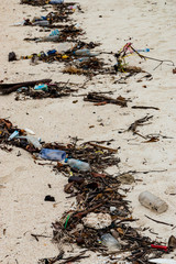 Huge amounts of garbage washed ashore on the hide tide line on a beach on a tropical island in Myanmar