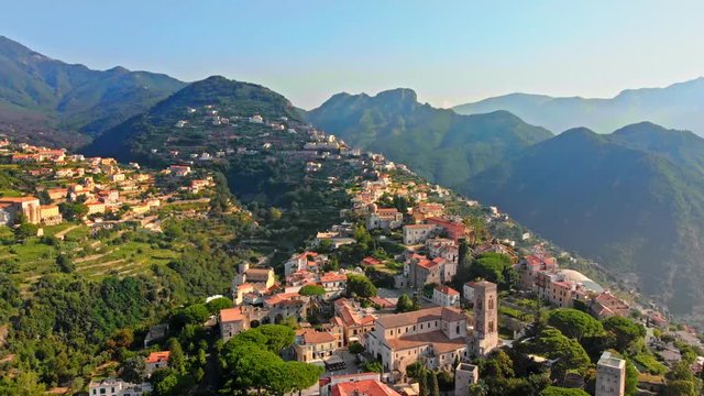 Aerial drone flight in ravello village on top of hill in the positano region of Italy showing a small hilltop village and mountains 4k