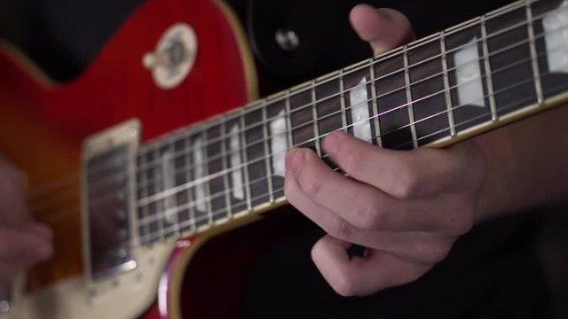 Slo-motion shot of a man playing a guitar solo