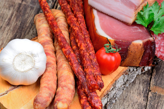 Different types of sausages on a wood cutting board