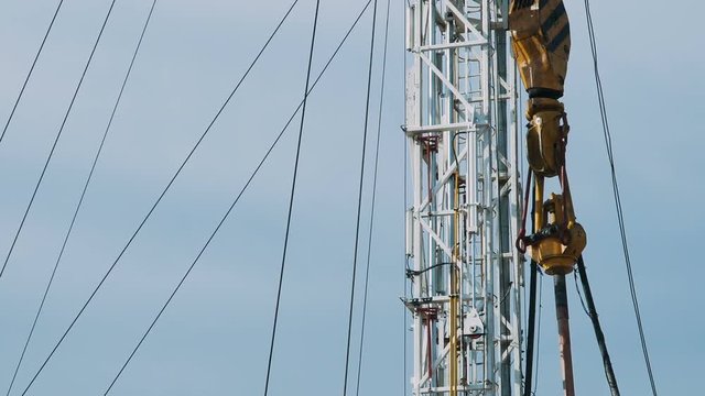 Top Drive System (TDS) Spinning for Oil Drilling Rig at blue sky - Oil and Gas Industry.
