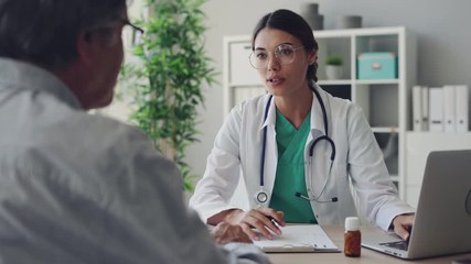 Doctor and patient are discussing at clinic - Powered by Adobe