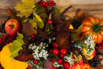 Pumpkins, apple, yellow fall leaves, top view