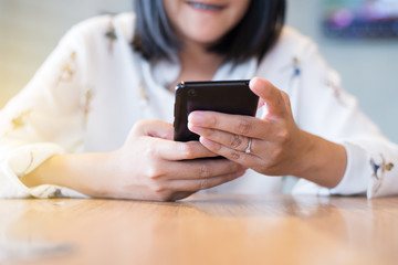 Hands woman using mobile phone,social media,connection wifi relaxed girl checking cell phone at restaurant