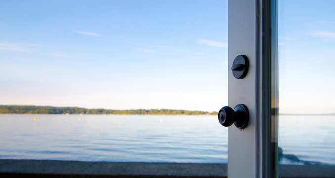 Opened french door leading to a beach