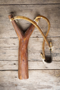 wood catapult slingshot on wood background
