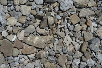 Natural background of stones of different sizes of gray.