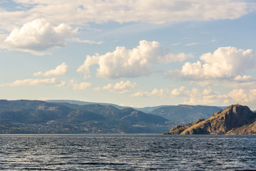 Okanagan lake at summer day with clouds on the sky.