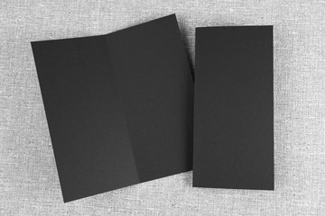 Mockup of black booklet on gray background.