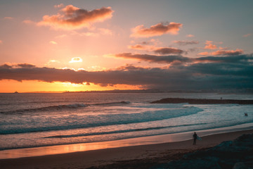 People walking at the beach sunset