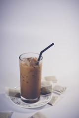 ice Coffee in the glass on white background.Vintage tone.