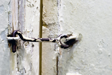 Old-fashioned way to lock a door. Door hook.