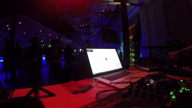 DJ playing beats on his drum machine at a night club in Atlanta, GA