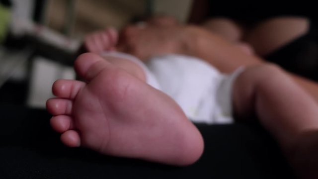 Woman breast feeding newborn low angle shot
