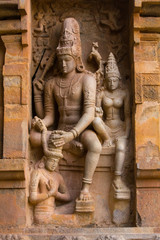 Fototapeta na wymiar Sculpture od lord Shiva and Parvathy on exterior wall of 11th century Shiva temple at Gangaikonda cholapuram, Tamilnadu, India