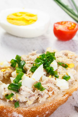 Closeup of baguette with fresh mackerel or tuna fish paste, healthy nutrition concept