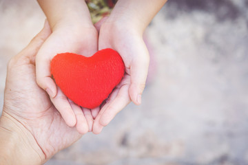Small kid hands holding heart