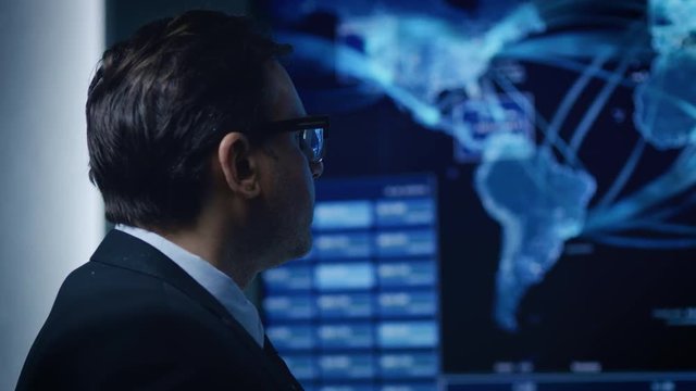 Portrait Shot of the Government Official / Politician Looking at the World Map with Data and Information Flow.