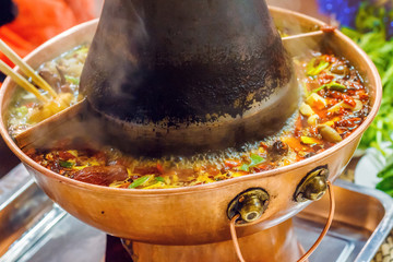 Asian traditional double flavor hot pot close-up