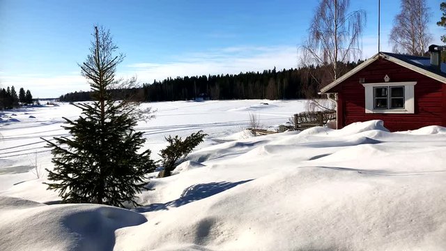 timelapse of nature and people moving around a cosy litle cabin in the north of Finland