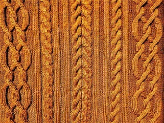 A brown knitted pattern with braids and cable-stitches