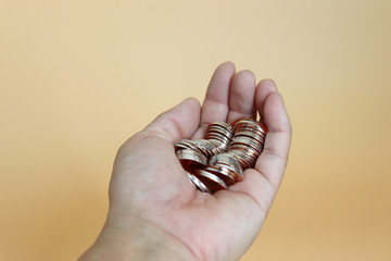 A heap of coins on the palm of one's hand.