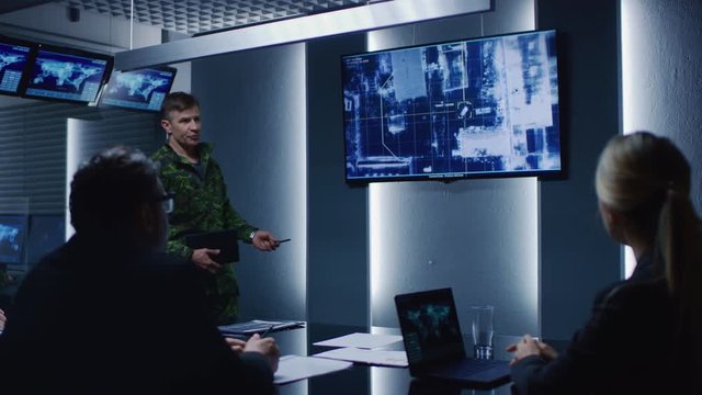 High-Ranking Military Man holds a Briefing to a Team of Government Agents and Politicians, Shows Footage of Satellite Following Target Car Surveillance. 