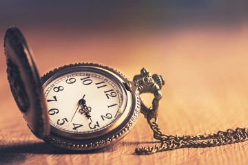Pocket watch on wooden  table background.