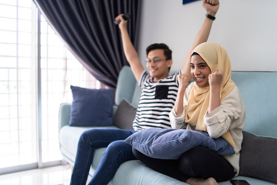 Asian Malay Couple Watching Tv Together