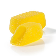 Yellow fruit chewy candy on a white background. Jelly Bean