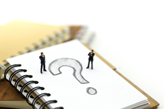 Miniature people : Businessman with THE QUESTION MARK using for concept Punctuation Day