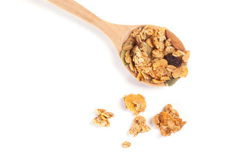 Close up Granola on the wooden spoon isolated on white background.