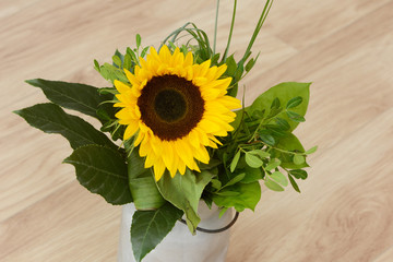 bouquet of sunflowers standig on wood