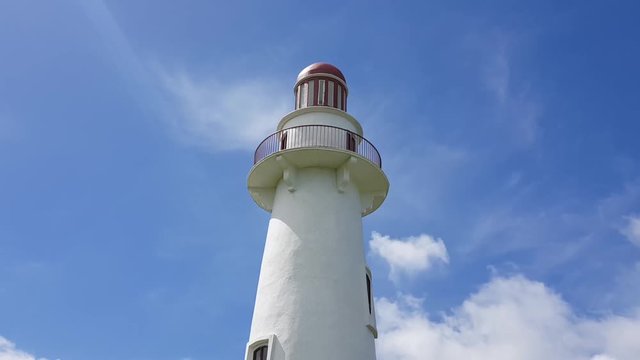 Timelapse of the Basco lighthouse with people at the top in Batanes, Philippines.