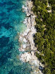 Aerial view of an amazing rocky and green coast bathed by a transparent and turquoise sea. Sardinia, Italy.