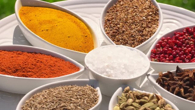 Dry spices on a rotary table. 4K. Macroshooting.