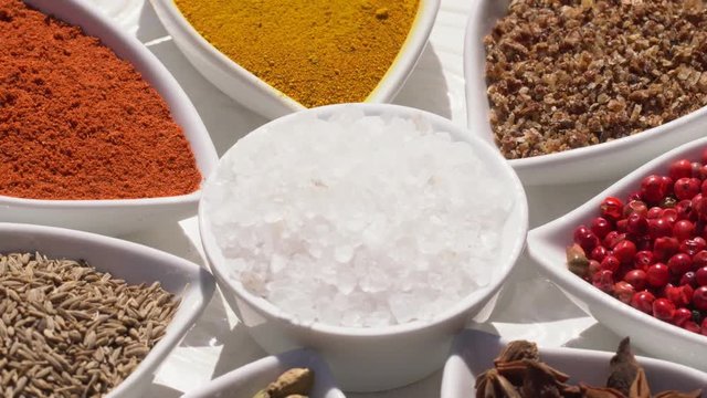 Dry spices on a rotary table. 4K. Macroshooting.