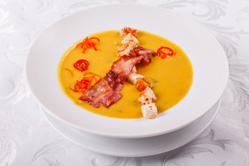 Traditional Spanish cold soup, with bread sticks and bacon chips. Corn Spanishwith bacon. chowder