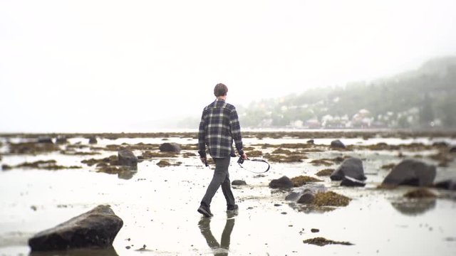 Man walking on beach into heaven, 4K, Norway, Europe.