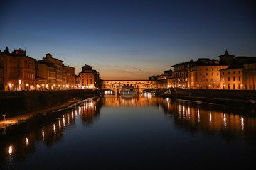 Florence, Italy, Arno river, view from Ponte alle Grazie at Ponte Vecchio, dark blue sky, yelow lamps, Lungarno Acciaiuoli