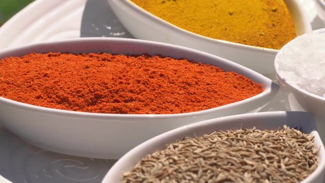 Dry spices on a rotary table. 4K. Macroshooting.