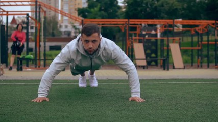 male sportsman pushes himself off the ground. guy claps while in mid-air.