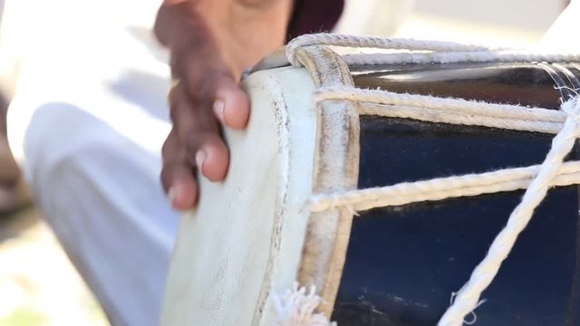 Man playing on a Bongo drum close up. Hand tapping a Bongo drum in close up. Jaisalmer fort, Rajasthan, India