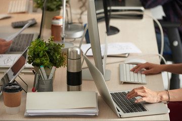 Coffee, documents and computers on table in office room