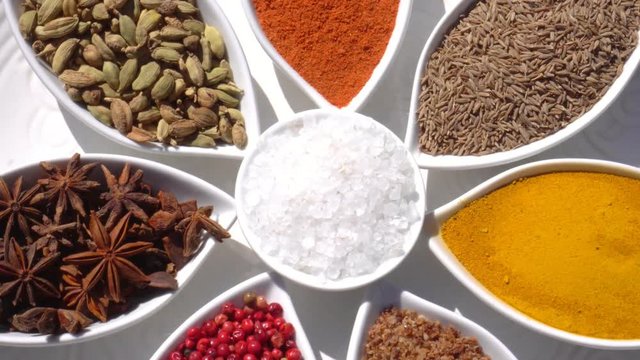 Dry spices on a rotary table. 4K. Macroshooting.
