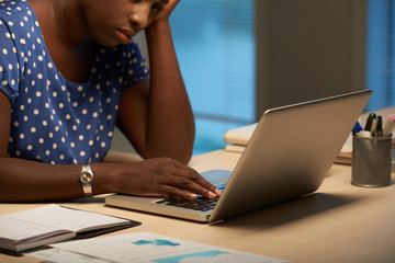 African-American business woman tired of working on laptop