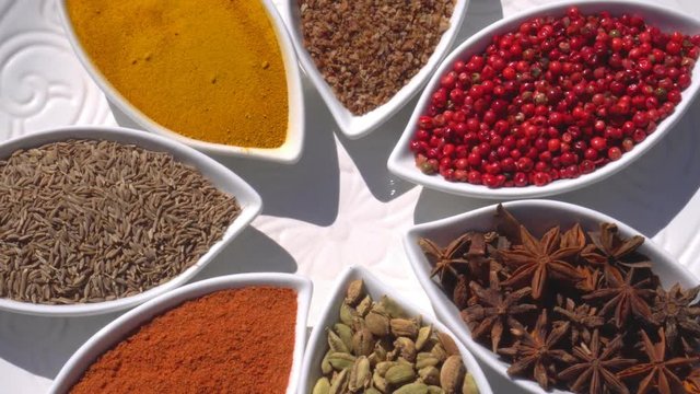 Dry spices on a rotary table. 4K. Macroshooting.