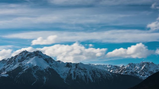 Time lapse of clouds rolling over peaks of Alps in Tyrol, Austria