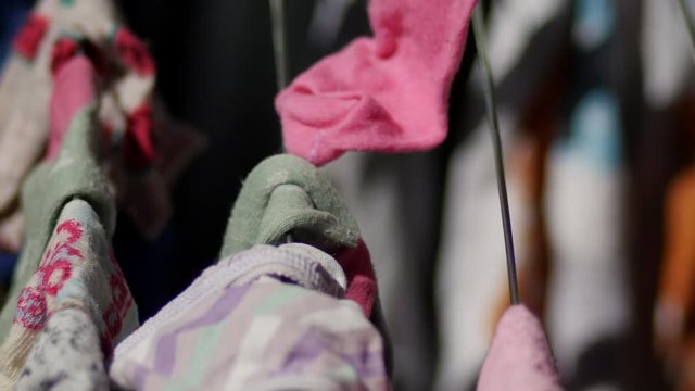 Dad's hand had hanged childs socks after they have been washed